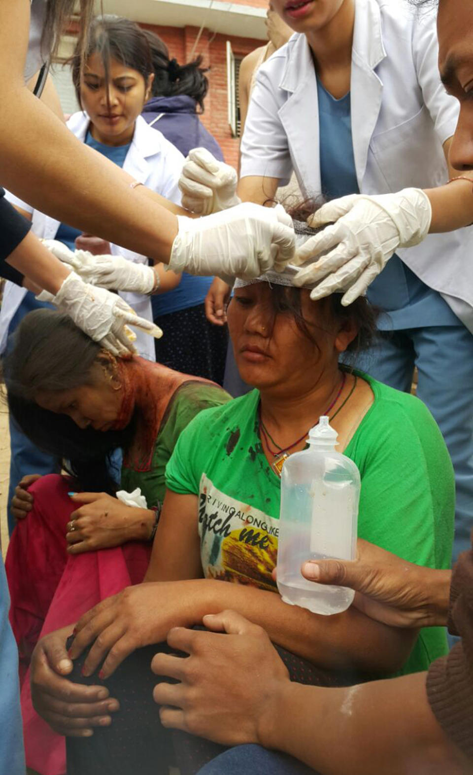 Injured people receive treatment in Kathmandu, April 25, 2015. (AP Photo/Tashi Sherpa)