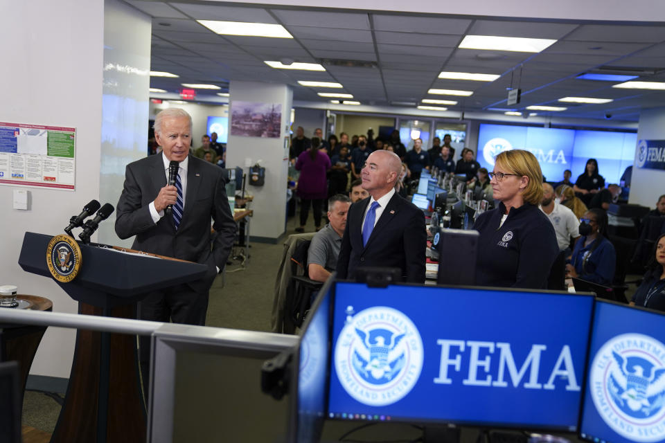 President Joe Biden speaks about Hurricane Ian during a visit to FEMA headquarters, Thursday, Sept. 29, 2022, in Washington. Homeland Security Secretary Alejandro Mayorkas and FEMA Administrator Deanne Criswell look on. (AP Photo/Evan Vucci)