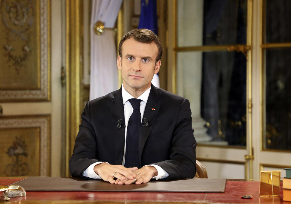 French President Emmanuel Macron poses before a special address to the nation, his first public comments after four weeks of nationwide 'yellow vest' protests, at the Elysee Palace, in Paris, Monday, Dec. 10, 2018. Facing exceptional protests, French President Emmanuel Macron is promising to speed up tax relief for struggling workers and to scrap a tax hike for retirees. (Ludovic Marin/Pool Photo via AP)