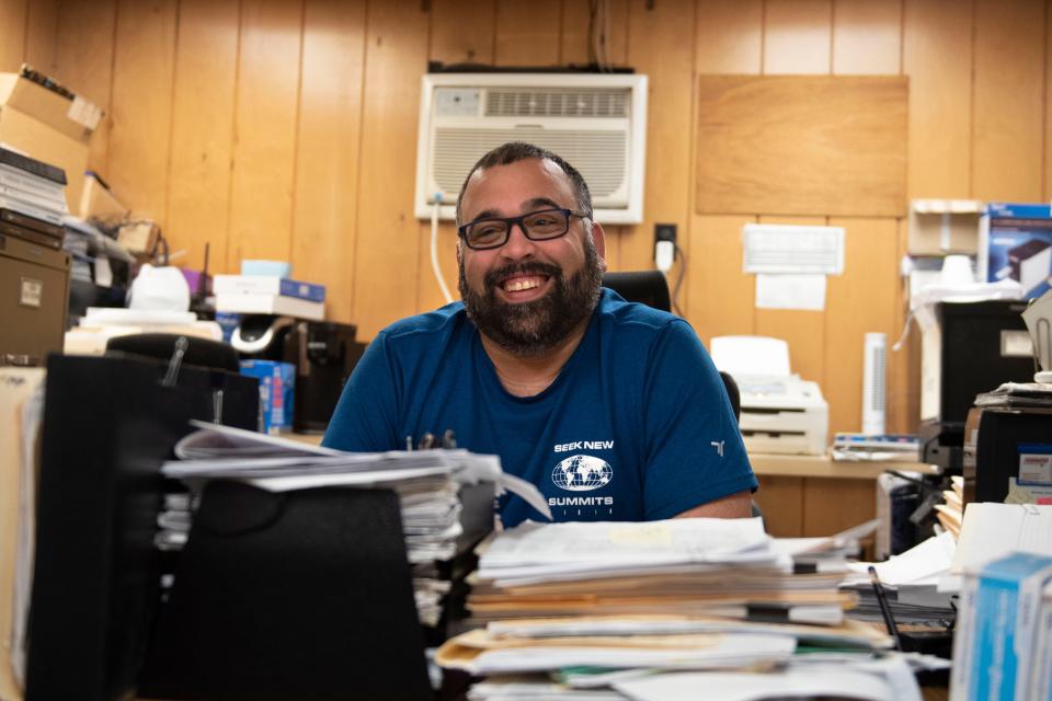 Store manager Edwin Herrera fields questions in his office at Selecto Supermarket in Bristol on Monday, Nov. 7, 2022.