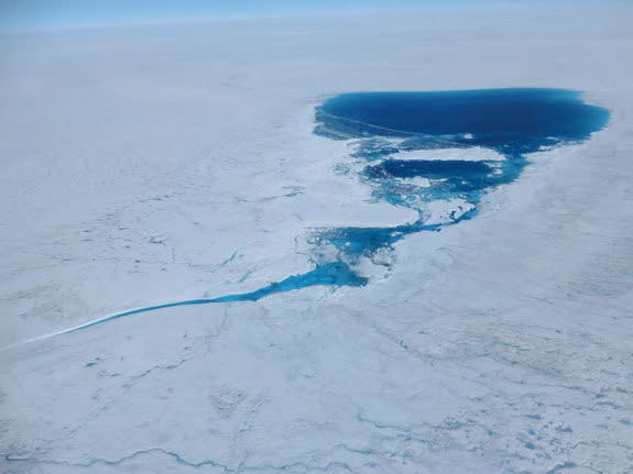 A supraglacial lake over the Greenland ice sheet in the Kangerlussuaq area photographed on July 21, 2012. The lake feeds a stream that will deliver meltwater to the low elevations where it will either flow to the ocean on the surface or dive in