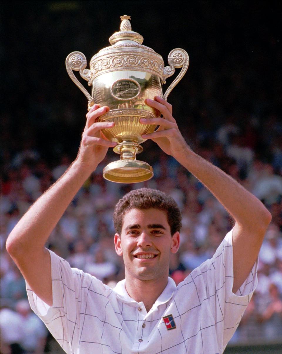 FILE - Pete Sampras holds his trophy, after defeating Boris Becker to win the Men's Singles Final on the Centre Court at Wimbledon Sunday July 9, 1995. Sampras defeated Becker 6-7 (5-7), 6-2, 6-4, 6-2 to win his third consecutive championship.(AP Photo/Dave Caulkin, File)