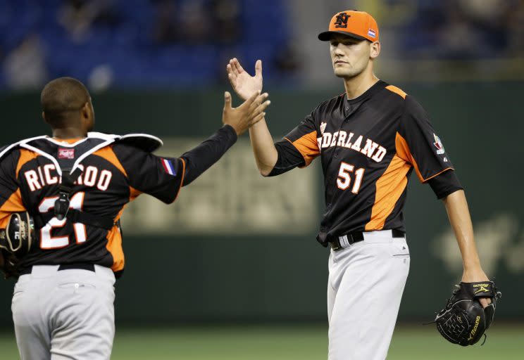 Netherlands' reliever Loek Van Mil, right, celebrates with catcher Dashenko Ricardo just after beating Cuba 6-2 in their World Baseball Classic second round baseball game at Tokyo Dome in Tokyo, Friday, March 8, 2013. (AP Photo/Koji Sasahara)