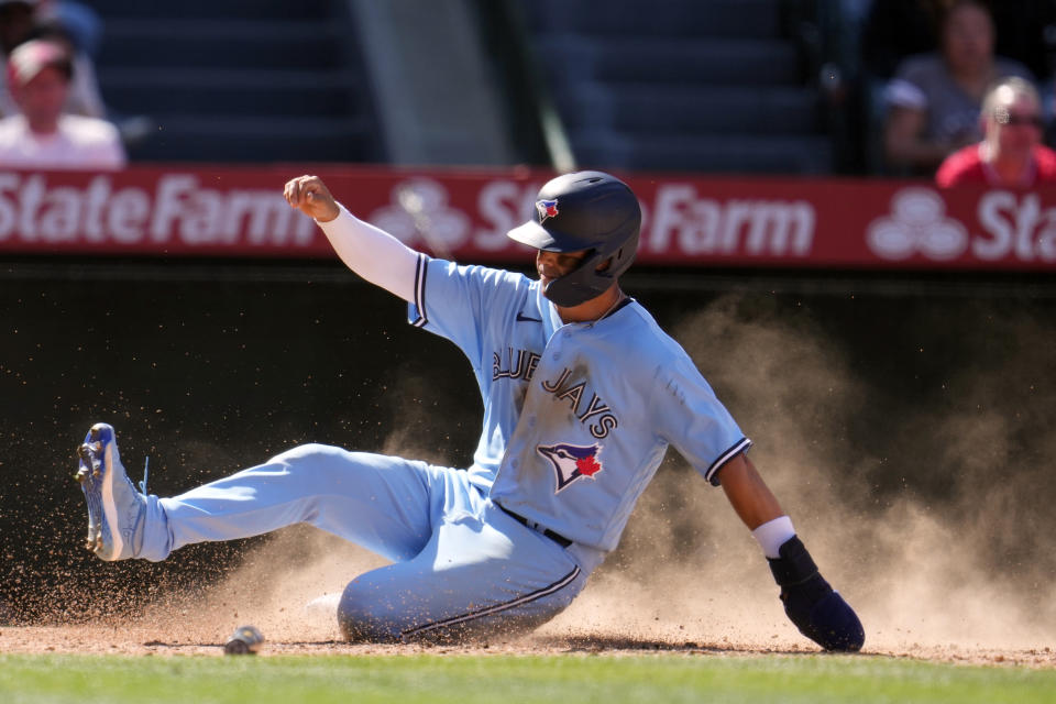 Toronto Blue Jays' Whit Merrifield scores on a single by Kevin Kiermaier during the seventh inning of a baseball game against the Los Angeles Angels, Sunday, April 9, 2023, in Anaheim, Calif. (AP Photo/Marcio Jose Sanchez)