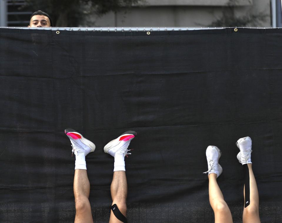 Legs facing toward the sky rest on a black tarp