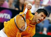 Novak Djokovic of Serbia serves to Kei Nishikori of Japan during their match at the Rome Open tennis tournament in Rome, Italy, May 15, 2015. REUTERS/Stefano Rellandini