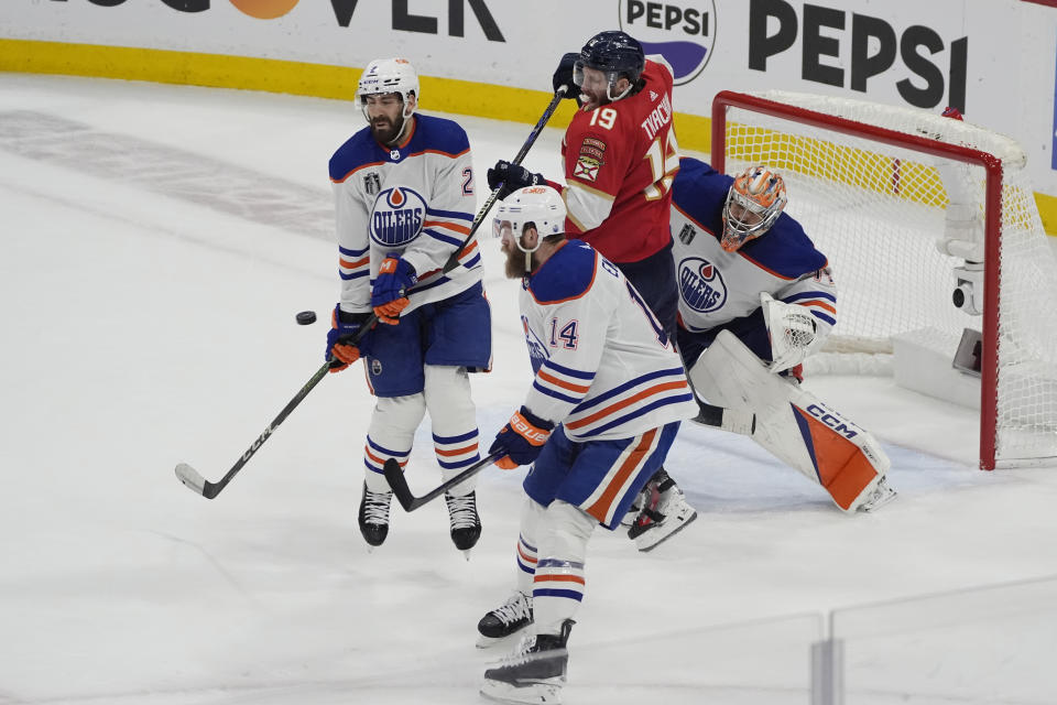 Edmonton Oilers defenseman Evan Bouchard (2) stops a shot on goal during the third period of Game 5 of the NHL hockey Stanley Cup Finals against the Florida Panthers, Tuesday, June 18, 2024, in Sunrise, Fla. (AP Photo/Rebecca Blackwell)