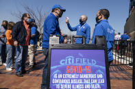 Fans arrive for COVID-19 screenings before entering Citifield before New York Mets home opening baseball game against the Miami Marlins, Thursday, April 8, 2021, in New York. (AP Photo/John Minchillo)