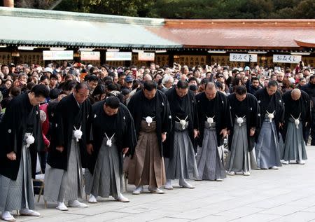 Sumo stable masters wearing traditional formal costumes bow before the New Year's ring-entering rite performed by sumo champions at the annual celebration for the New Year at Meiji Shrine in Tokyo, Japan, January 6, 2017. REUTERS/Issei Kato