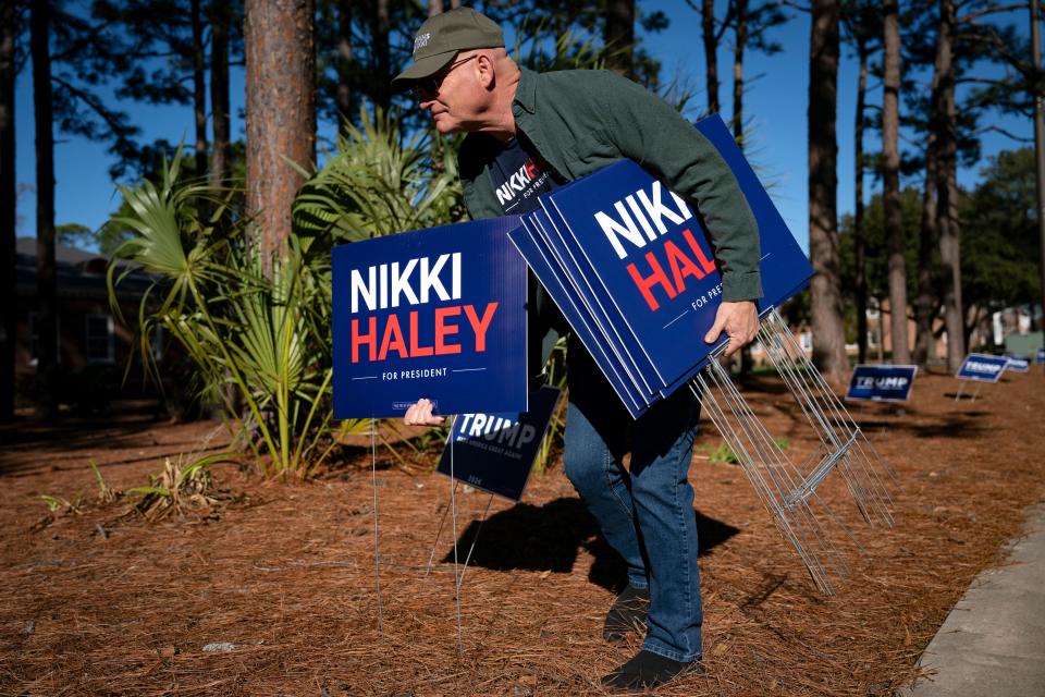 A man places signs outside a rally for Republican presidential candidate and former UN Ambassador Nikki Haley on January 28, 2024 in Conway, South Carolina.