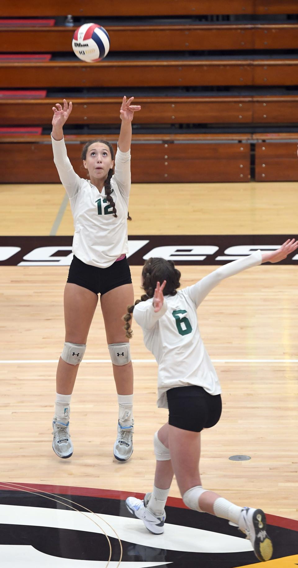 Boca Raton Christian's Caitlin Crino (12) sets one for Natalie Marciante (6) in their semifinal game against Oak Hall during the FHSAA Girls Volleyball State Championships held at Polk State College in Winter Haven on Monday, Nov. 6, 2023. Boca Raton Christian defeated Oak Hall in straight sets.