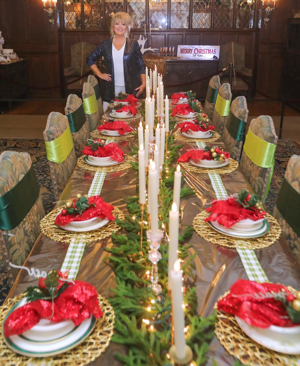 Copley designer Jill Pangas shows the dining room that she decorated for Christmas at Stan Hywet Hall on Wednesday in Akron.