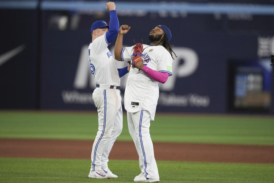 Toronto Blue Jays' Vladimir Guerrero Jr., right, and Matt Chapman, left, celebrate after their win over the Boston Red Sox in a baseball game in Toronto, Friday, Sept. 15, 2023. (Chris Young/The Canadian Press via AP)