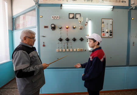 A teacher listens to a student during an electrician class lesson at a college of ferrous metallurgy in the town of Aksu, north-eastern Kazakhstan, February 22, 2018. REUTERS/Shamil Zhumatov/Files