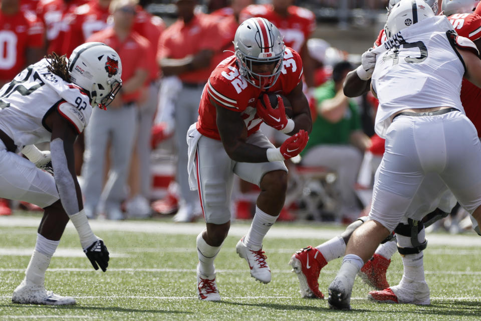 Ohio State running back TreVeyon Henderson, right, cuts up field between Arkansas State defenders during the second half of an NCAA college football game Saturday, Sept. 10, 2022, in Columbus, Ohio. (AP Photo/Jay LaPrete)