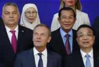 European Council President Donald Tusk, bottom left, and China's Prime Minister Li Keqiang, bottom right, pose for a group photo at an EU-ASEM summit in Brussels, Friday, Oct. 19, 2018. EU leaders met with their Asian counterparts Friday to discuss trade, among other issues. (AP Photo/Alastair Grant)