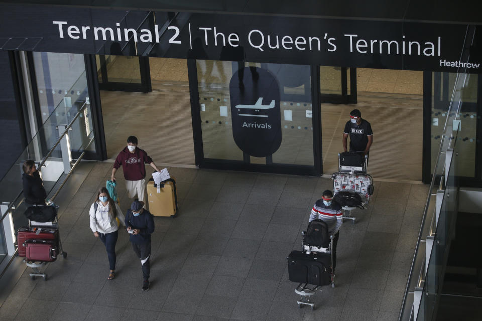 LONDON, ENGLAND - AUGUST 22: Travellers exit Heathrow Airport Terminal 2 on August 22, 2020 in London, England. As of Saturday morning at 4am, travellers arriving in England from Austria, Croatia, and Trinidad and Tobago were required to quarantine themselves for 14 days. At the same time, travellers from Portugal were no longer required to quarantine. (Photo by Hollie Adams/Getty Images)