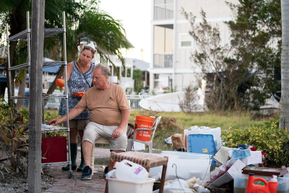 People in Naples, Florida go through family photos damaged by floodwaters in Hurricane Ian (Getty Images)