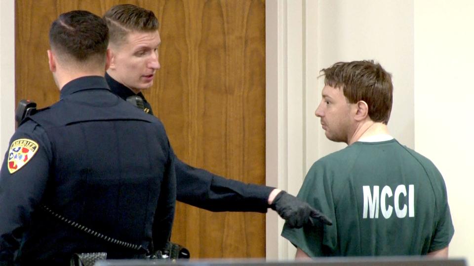 A Monmouth County Sheriff's Officer direects Kenneth H. Knapp Jr., to the jury box during his sentencing for the aggravated manslaughter of his father, Kenneth Knapp Sr., and desecrating his remains. The sentencing was held before Judge Henry P. Butehorn at the Monmouth County Courthouse in Freehold Thursday, April 18, 2024.