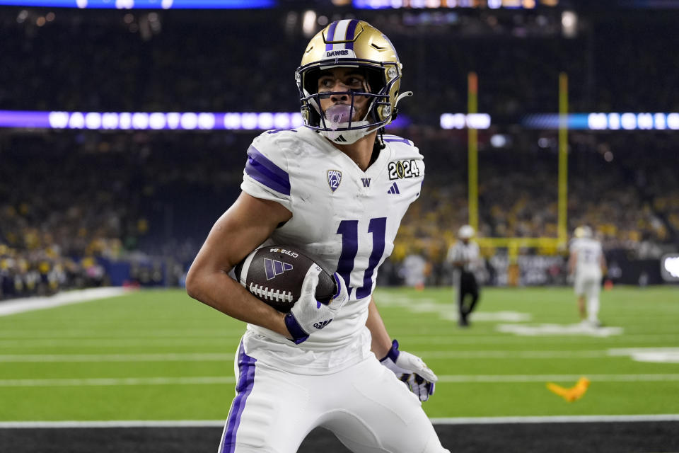 Washington wide receiver Jalen McMillan celebrates after scoring against Michigan during the first half of the national championship NCAA College Football Playoff game Monday, Jan. 8, 2024, in Houston. (AP Photo/David J. Phillip)