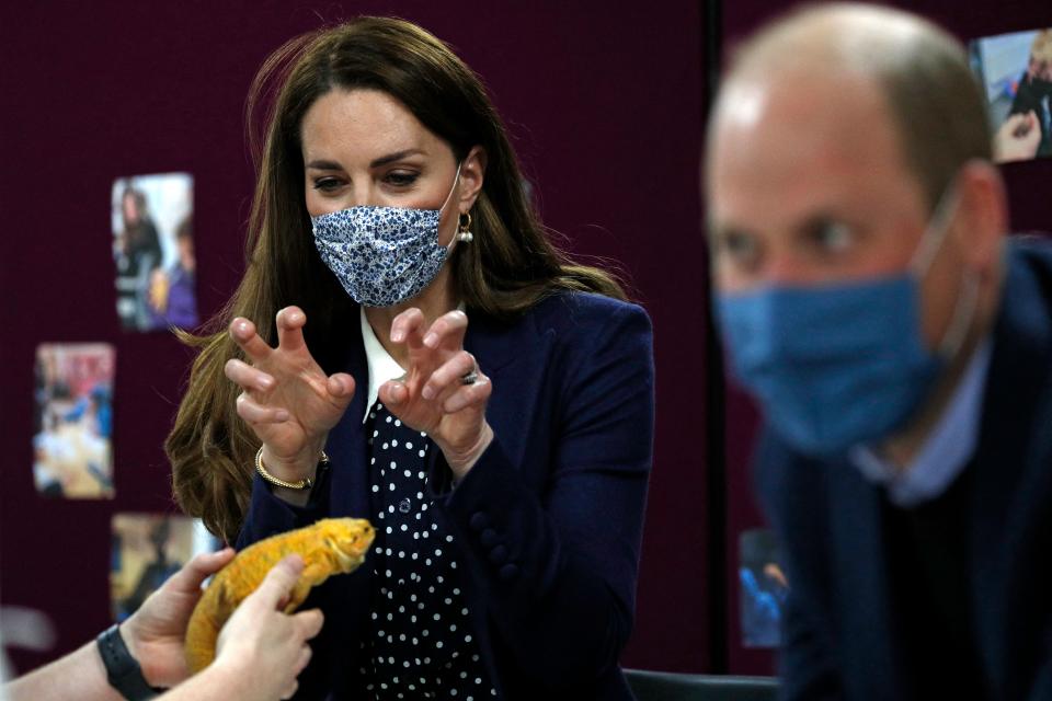 Britain's Catherine, Duchess of Cambridge, gestures at a chameleon as she joins a group of local school children from Loxdale Primary School during a visit to HugglePets in the Community to mark mental health awareness week in Wolverhampton on May 13, 2021. - HugglePets in the Community works with over 25 different schools in the Black Country, offering Animal Assisted Intervention programmes supporting children with their mental wellbeing on topics including anxiety, low mood, confidence and resilience building and suicide awareness. (Photo by Adrian DENNIS / POOL / AFP) (Photo by ADRIAN DENNIS/POOL/AFP via Getty Images)