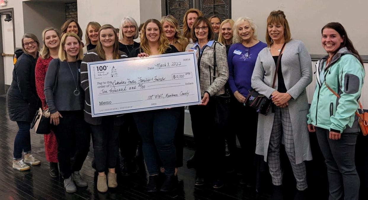 Lakeshore Foster Families & Friends receives a check for $10,000 at the last meeting of Manitowoc County 100+ Women Who Care.