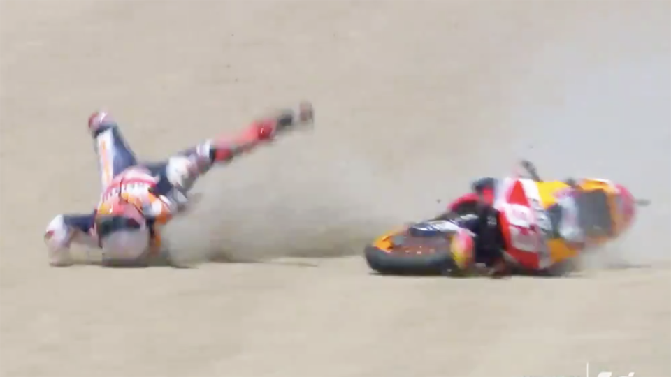 A screenshot shows MotoGP champion Marc Marquez bouncing across the gravel trap after he was thrown from his bike.