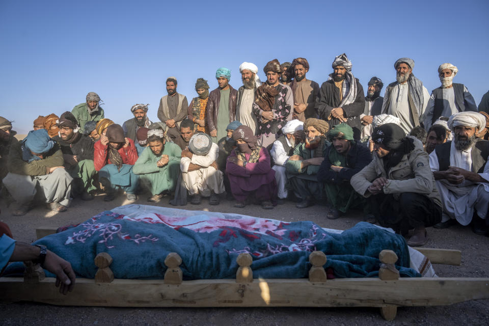 Afghans pray for relatives killed in an earthquake to a burial site after an earthquake in Zenda Jan district in Herat province, western of Afghanistan, Sunday, Oct. 8, 2023. Powerful earthquakes killed at least 2,000 people in western Afghanistan, a Taliban government spokesman said Sunday. It's one of the deadliest earthquakes to strike the country in two decades. (AP Photo/Ebrahim Noroozi)