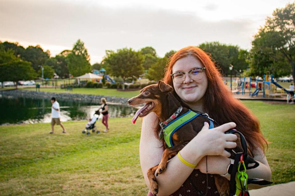 Pet sitter Haley Ritter with Winston, on a walk at Belle Johnston Park in Pineville, North Carolina.