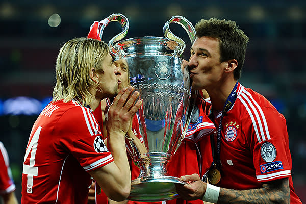 Anatoliy Tymoshchuk of Bayern Muenchen (L) and team-mate Mario Mandzukic kiss the trophy after winning the UEFA Champions League final.