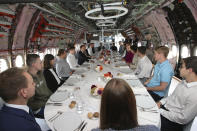 French President Emmanuel Macron and German Chancellor Angela Merkel, center right, share a lunch with high school children and apprentices in Toulouse, southwestern France, Wednesday, Oct.16, 2019. French President Emmanuel Macron and German Chancellor Angela Merkel are meeting in southern France, one day before a key EU summit that may approve a divorce deal with Britain. (AP Photo/Frederic Scheiber, Pool)