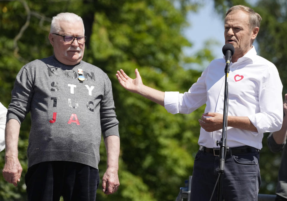 Centrist opposition party leader Donald Tusk, right, and Lech Walesa, who along with other critics accuses the government of eroding democracy, lead an anti-government march in Warsaw, Poland, Saturday June 4, 2023. The march is being held on the 34th anniversary of the first democratic elections in 1989 after Poland emerged from decades of communist rule. (AP Photo/Czarek Sokolowski)