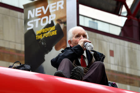 Phil Kingston, 83, sits on top of a DLR train as demonstrators block traffic at Canary Wharf Station during the Extinction Rebellion protest in London, Britain April 25, 2019. REUTERS/Dylan Martinez