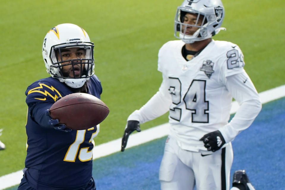 Los Angeles Chargers wide receiver Keenan Allen, left, scores a touchdown during the first half of an NFL football game against the Las Vegas Raiders, Sunday, Nov. 8, 2020, in Inglewood, Calif. (AP Photo/Alex Gallardo)