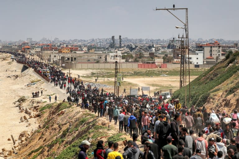 Palestinos desplazados caminan por Nuseirat, en el centro de la Franja de Gaza, hacia Ciudad de Gaza, el 14 de abril de 2024 (-)