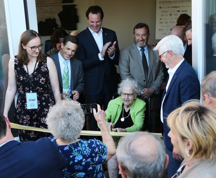 Ruth Lewin Griffin cuts the ribbon during the official dedication of the new affordable housing development in downtown Portsmouth named in her honor Wednesday, June 9, 2022.