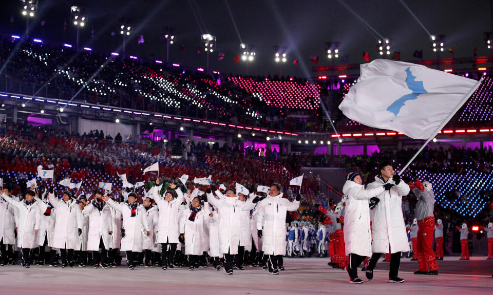 FILE - In this Feb. 9, 2018, file photo, North Korea's Hwang Chung Gum and South Korea's Won Yun-jong carry the unification flag during the opening ceremony of the 2018 Winter Olympics in Pyeongchang, South Korea. (AP Photo/Jae C. Hong, File)