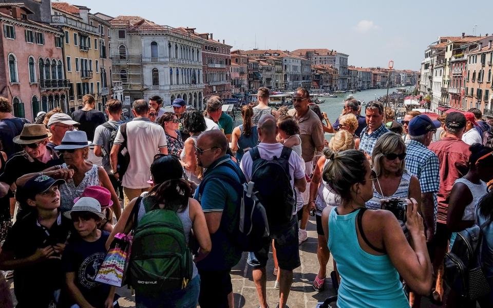 Tourists on Rialto bridge in Venice