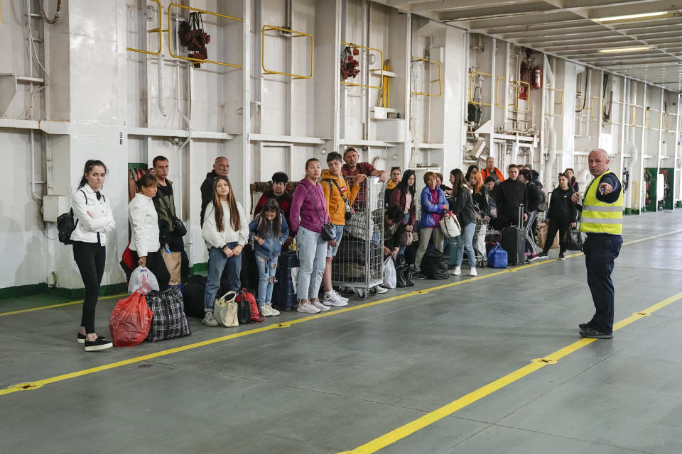 Ukrainian refugees line up as they arrive to get accommodations on the ferry Isabelle in Tallinn, Estonia, Wednesday, June 15, 2022. Around 2,000 refugees from Ukraine live on the ferry. (AP Photo)