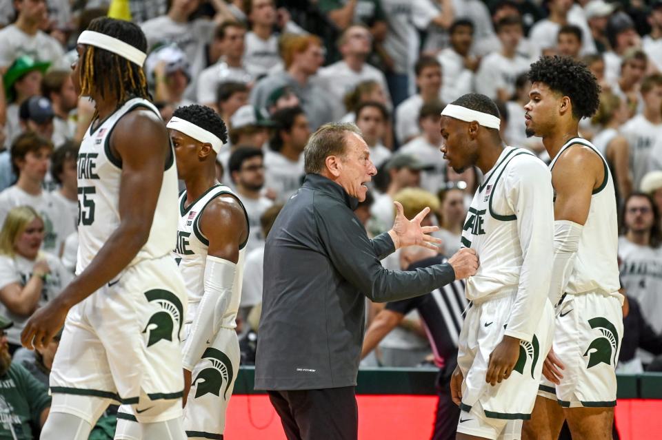 Michigan State's head coach Tom Izzo, center, talks to Tre Holloman during timeout during overtime against James Madison on Monday, Nov. 6, 2023, in East Lansing.