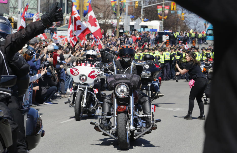 Demonstrators on motorcycles ride near the National War Memorial, part of a convoy-style protest participants are calling "Rolling Thunder" in Ottawa, Ontario, Saturday, April 30, 2022. (Patrick Doyle/The Canadian Press via AP)