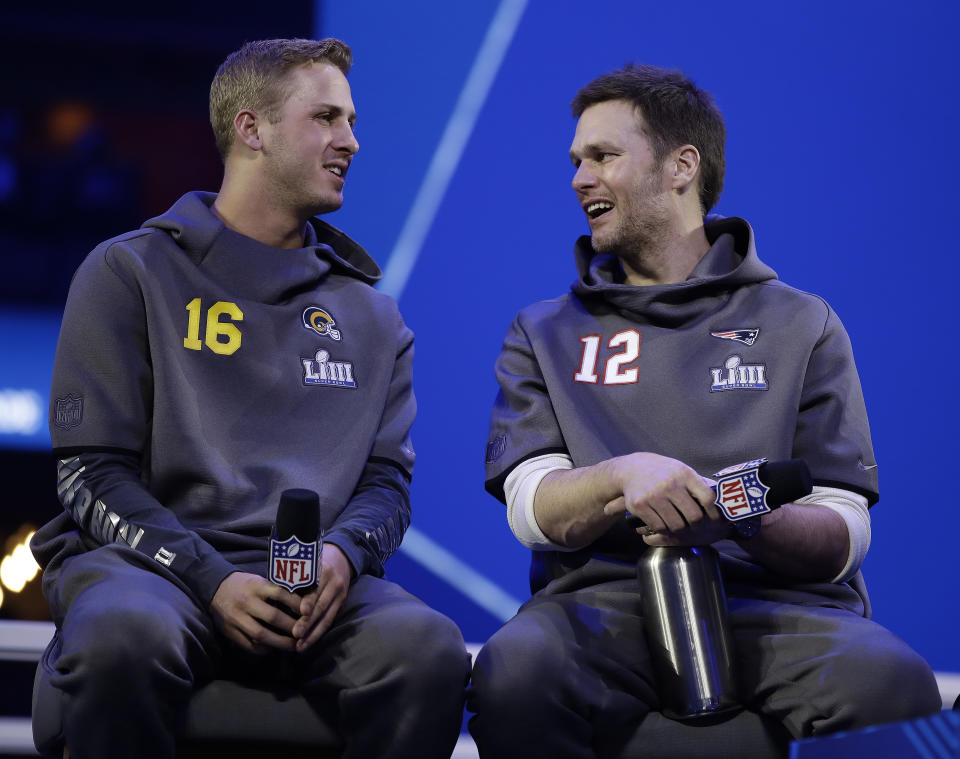 Los Angeles Rams' Jared Goff talks to New England Patriots' Tom Brady during Opening Night for the NFL Super Bowl 53 football game Monday, Jan. 28, 2019, in Atlanta. (AP Photo/Matt Rourke)