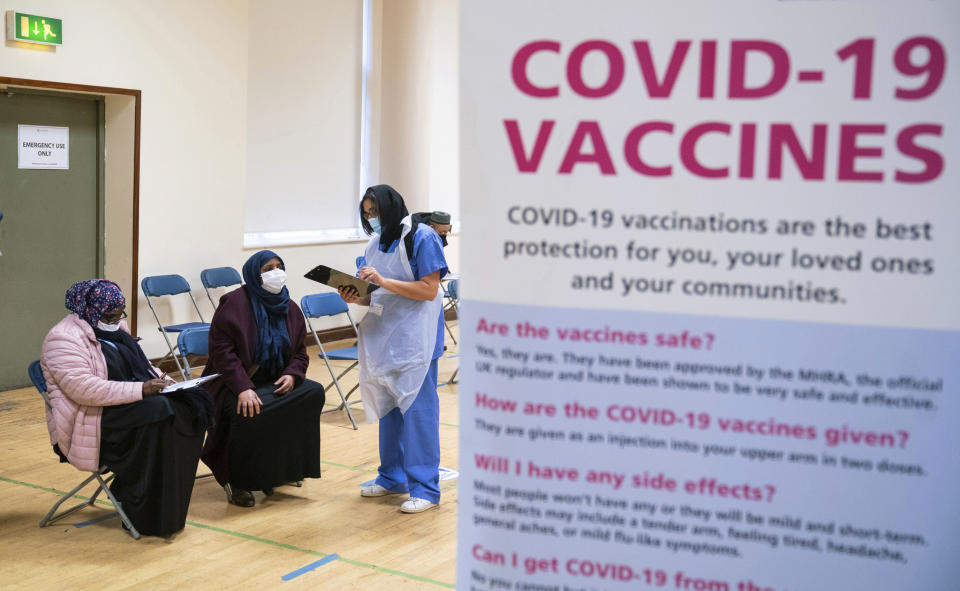 People attend a pop-up Covid-19 vaccination centre, at the East London Mosque in Whitechapel, London, Saturday Feb. 6, 2021. Britain's vaccination program is pushing to offer a vaccination to aged, vulnerable and care workers by mid-February. (Dominic Lipinski/PA via AP)