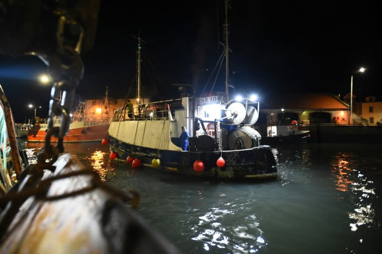 Commercial fishing boats pictured preparing to leave at dawn from Pittenweem Harbour in Fife, Scotland on December 9, 2018