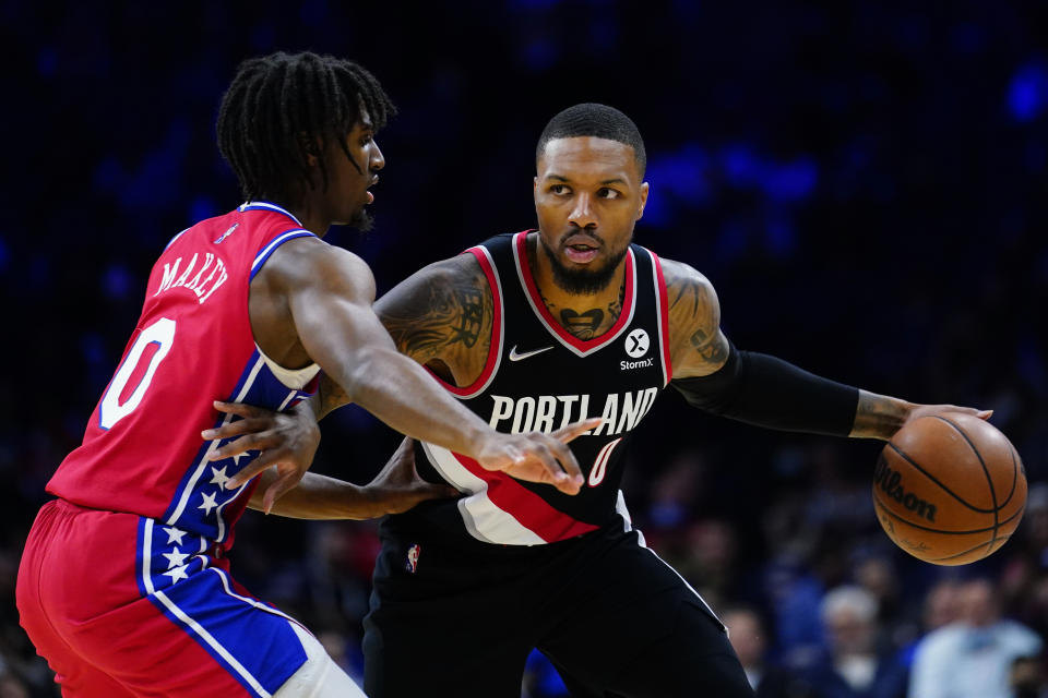 Portland Trail Blazers' Damian Lillard, right, tries to get past Philadelphia 76ers' Tyrese Maxey during the first half of an NBA basketball game, Monday, Nov. 1, 2021, in Philadelphia. (AP Photo/Matt Slocum)