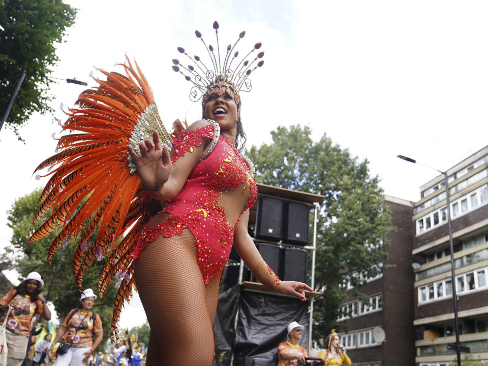 Participants dance along Westbourne Park, during the adults parade, part of the Notting Hill Carnival celebration, in west London, Monday, Aug. 28, 2023. ( James Manning/PA via AP)