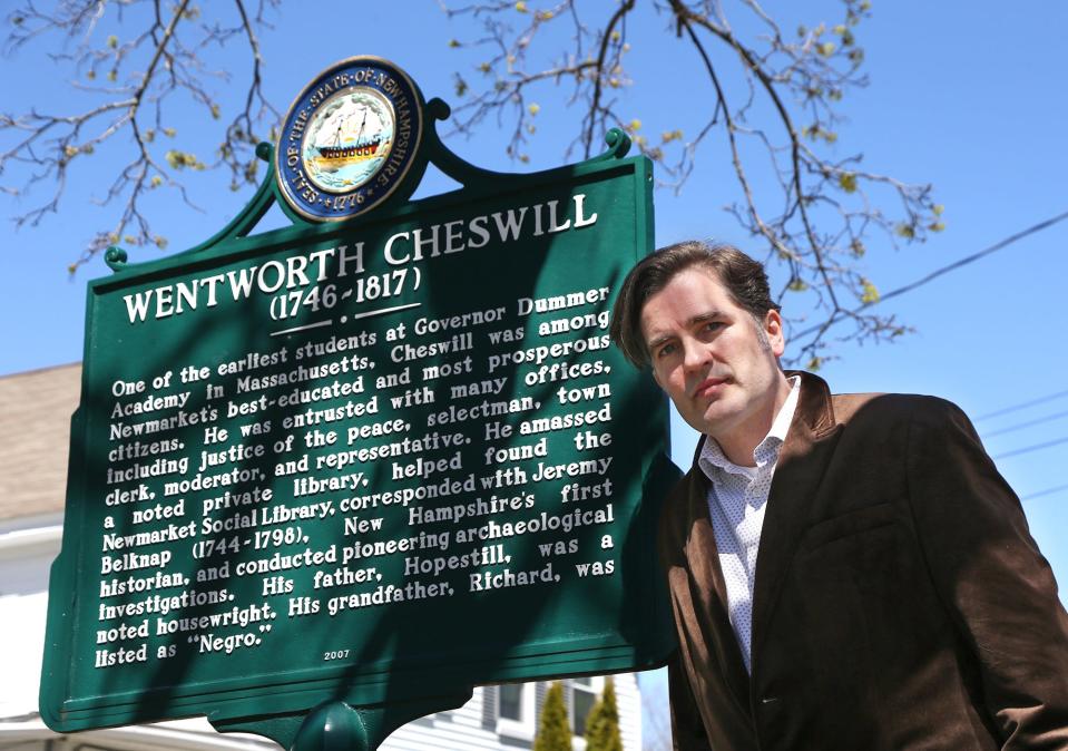 John Herman, who recently released the book ‘Wentworth Cheswill’s Ride,’ stands beside the historical marker that honors Cheswill and his family, whose final resting place is in the Newmarket cemetery.
