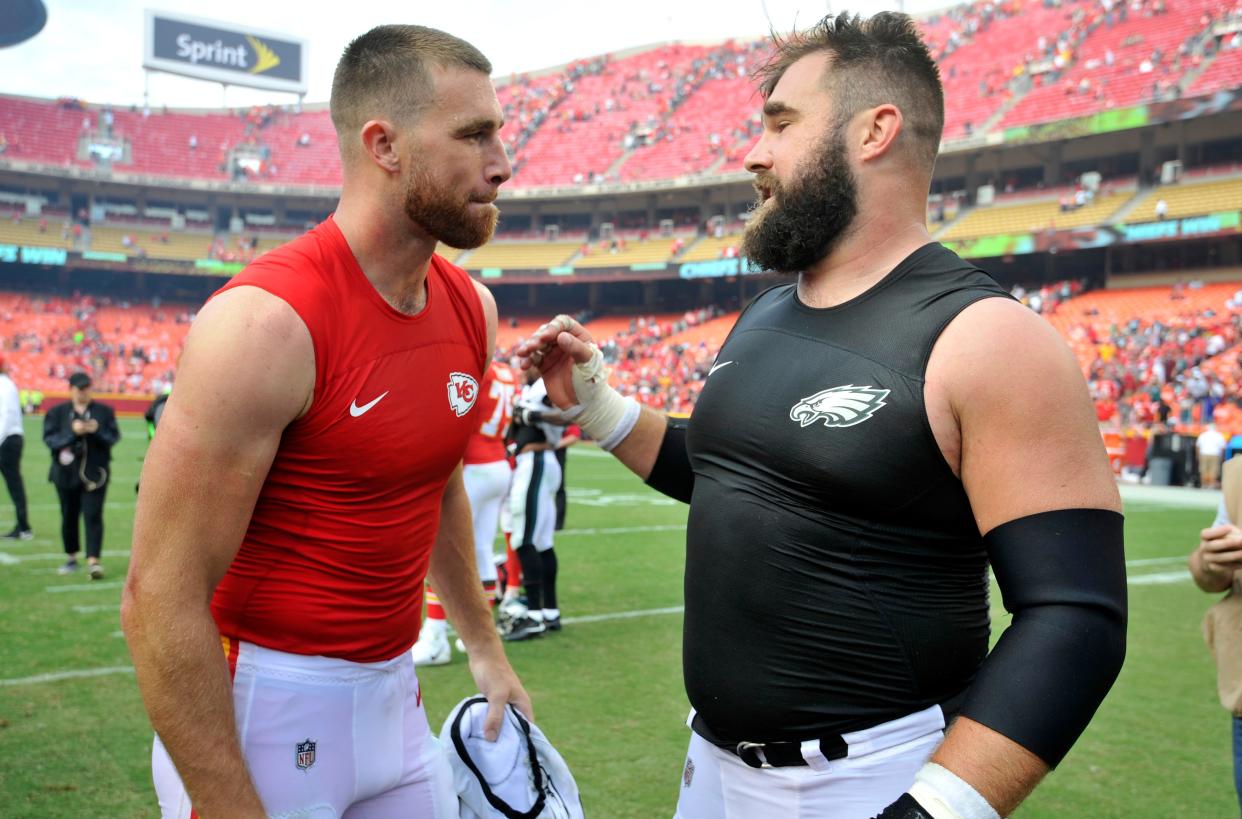 Kansas City Chiefs tight end Travis Kelce, left, talks to his brother, Philadelphia Eagles center Jason Kelce, after they exchanged jerseys following a 2017 game in Kansas City.