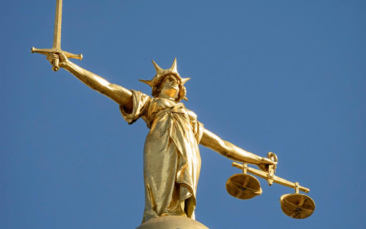 Close-up of the statue of Lady Justice, holding a sword and the scales of justice, located on top of the dome above the Old Bailey (Central Criminal Court) in London. Lady Justice is based on Justitia, the Roman goddess of justice. - Getty Images
