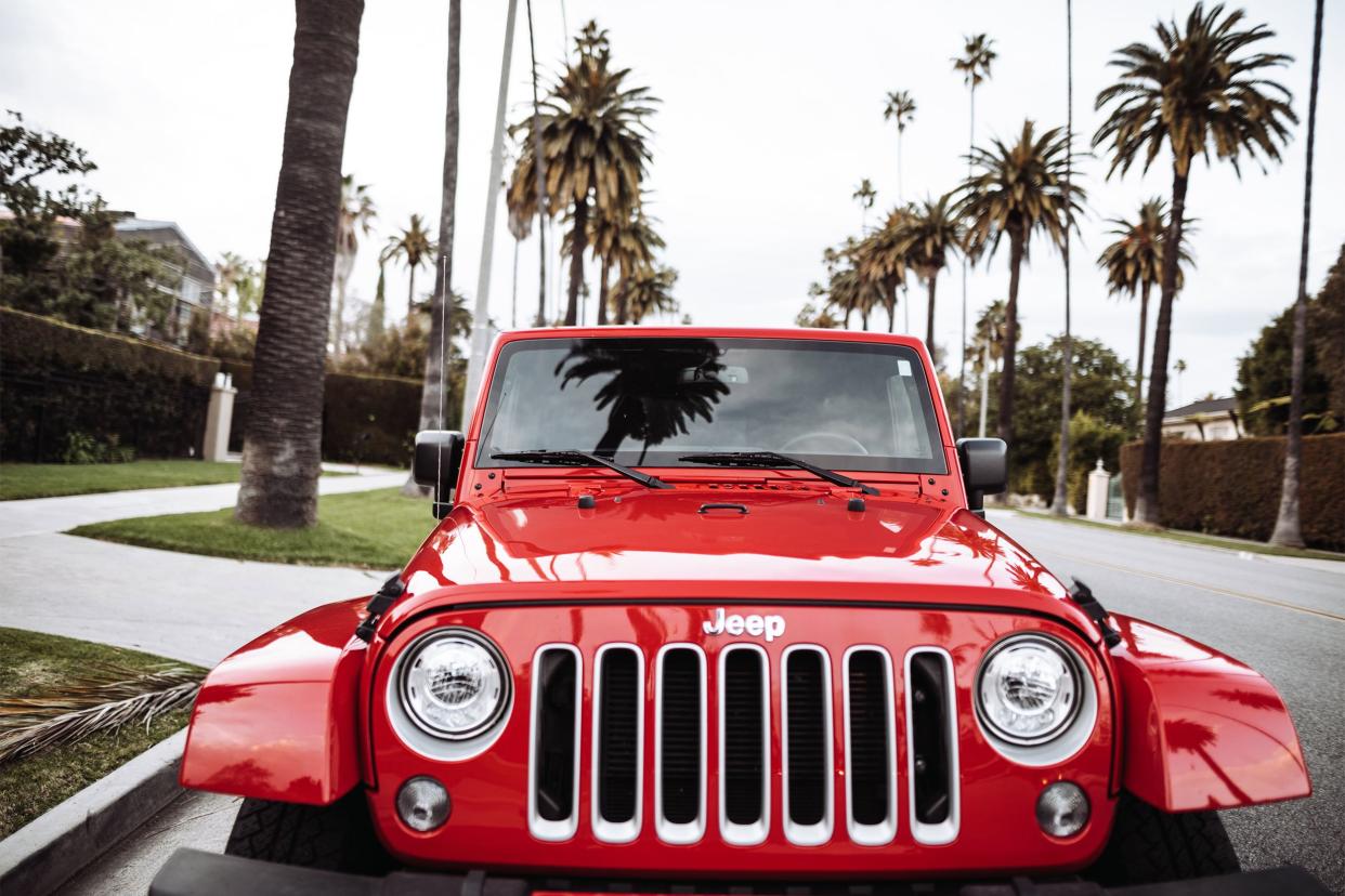 Red shiny 2019 Jeep Wrangler in Beverly Drive Los Angeles.